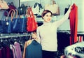 Female shopper examining turtleneck sweaters in womenÃ¢â¬â¢s cloths Royalty Free Stock Photo